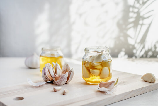 Fermented garlic cloves in a jar of honey. Healthy food and medicine from nature, honey for strong immunity, Fermented honey with garlic, a rich source of probiotics