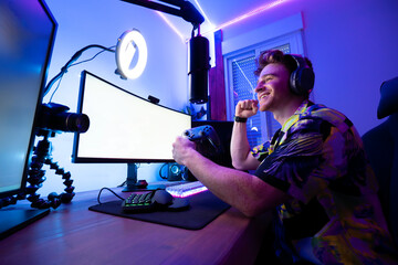 Cheerful man playing computer game