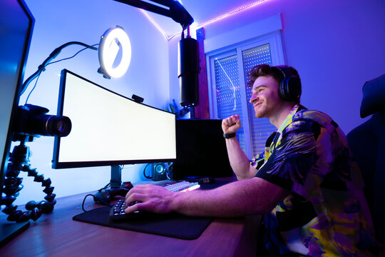 Cheerful man playing computer game