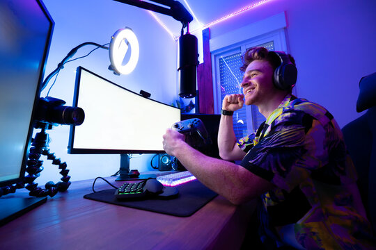 Cheerful man playing computer game