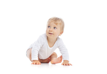 Little, happy and smiling cute baby in the studio. Portrait of a one year old baby. The concept of happiness.