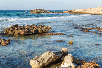 Rocky seashore against a clear blue sky. Beautiful landscape.