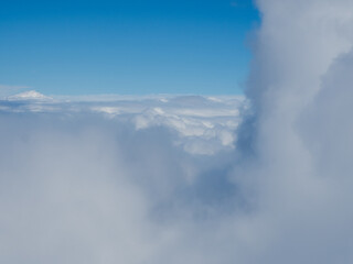 Naklejka na ściany i meble High fluffy clouds seen from the height