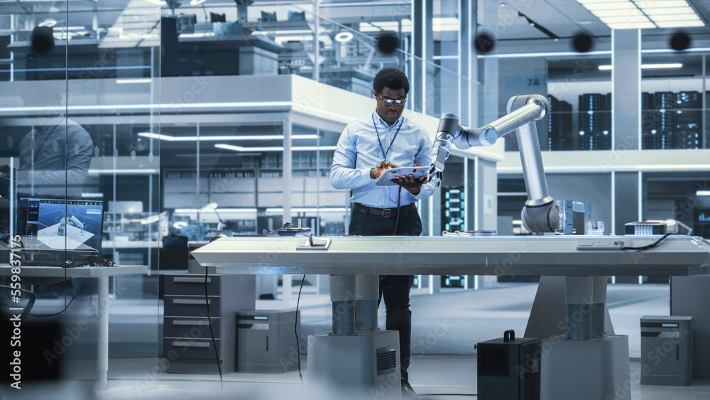 Poster young african american male engineer using a tablet computer, researching and developing a futuristi