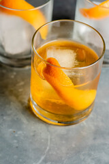Old fashioned or Manhattan cocktail. Classic American drink with rye whiskey or bourbon, muddled maraschino cherries, oranges and sugar. Shaken, served over ice and garnished with an orange peel.