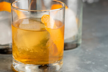 Old fashioned or Manhattan cocktail. Classic American drink with rye whiskey or bourbon, muddled maraschino cherries, oranges and sugar. Shaken, served over ice and garnished with an orange peel.