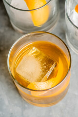 Old fashioned or Manhattan cocktail. Classic American drink with rye whiskey or bourbon, muddled maraschino cherries, oranges and sugar. Shaken, served over ice and garnished with an orange peel.