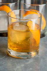 Old fashioned or Manhattan cocktail. Classic American drink with rye whiskey or bourbon, muddled maraschino cherries, oranges and sugar. Shaken, served over ice and garnished with an orange peel.