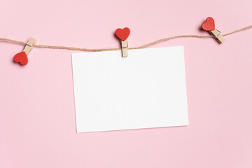 Valentines Day blank greeting card mockup with heart peg or clothespin hanging on a rope