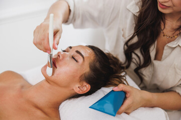 Obraz na płótnie Canvas Woman Getting A Facial Mask Treatment At The Beauty Salon