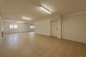 Empty living room of a ground floor residential detached house with tiled floors, French style...