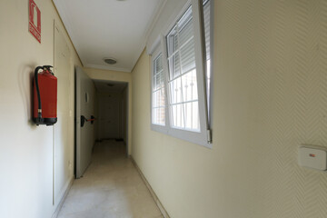 Residential apartment building corridor with fireproof doors and aluminum windows