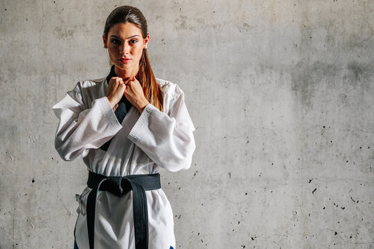Confident woman in taekwondo coat