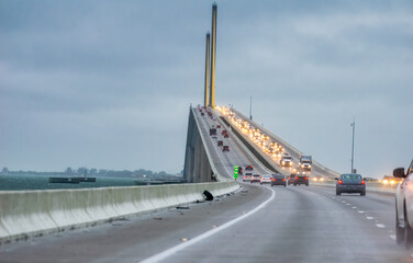 Traffic at sunset along a brige over the sea