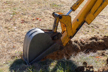 Excavator Starting to Dig a Trench for Foundation - 559843502