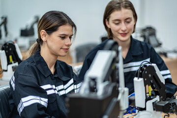 Team woman of engineers practicing maintenance Taking care and practicing maintenance of old machines in the factory so that they can be used continuously.