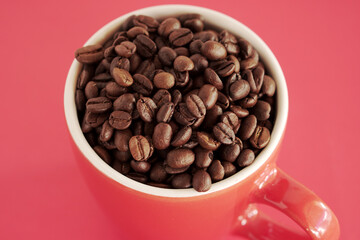 coffee beans in a cup on red background