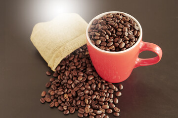 coffee beans in a cup on black background