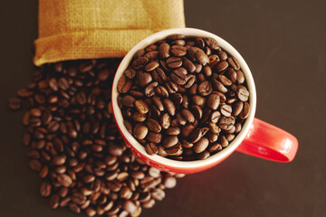 coffee beans in a cup on black background