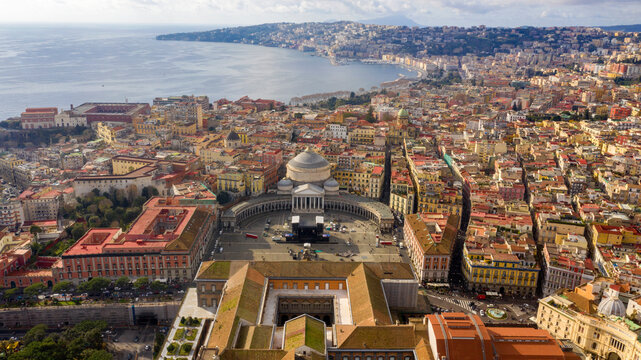 Aerial view of Piazza del Plebiscito, a large public square in the historic center of Naples, Italy. It's bounded by the Basilica of San Francesco di Paola and the royal palace of the city.