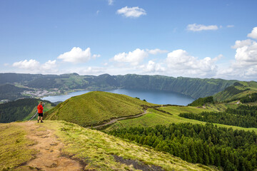 Hiker enjoying the scenic views of the caldera on São Miguel island in the Azores