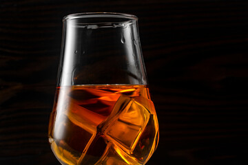 Glass of whiskey with ice.