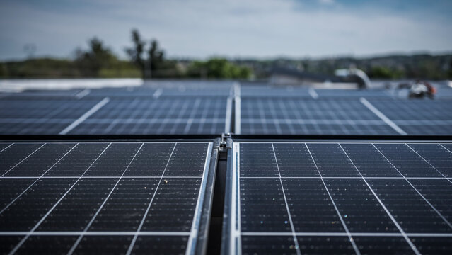 Solar panels being installed on the roof of an industrial company