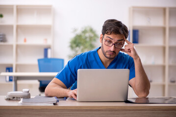 Young male doctor in telemedicine concept