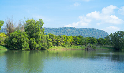 Fototapeta na wymiar Green mountain hill with lake or river reflection. Nature landscape background, Thailand.