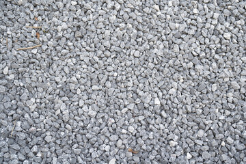 Granite gravel stone rocks flooring pattern surface texture. Close-up of exterior material for design decoration background. Rubble