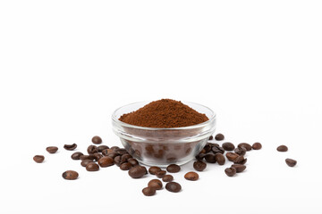 Ground coffee and coffee beans in a bowl isolated on white background.