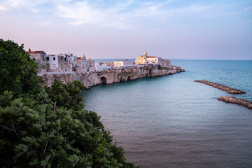 Scenic sunset view over historic old town and church of San Francesco, Vieste, Gargano, Apulia, Italy	