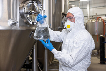 Fototapeta premium Brewer overseeing the beer production process in the factory