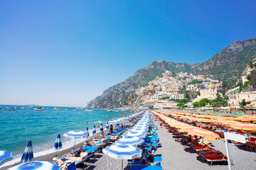 Sea and row of umbrellas on beach of Positano - famous old italian resort, Italy