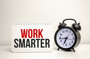 WORK SMARTER words with clock with notebook