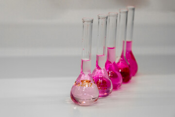 Composition of laboratory material with colored liquids in realistic glass pots