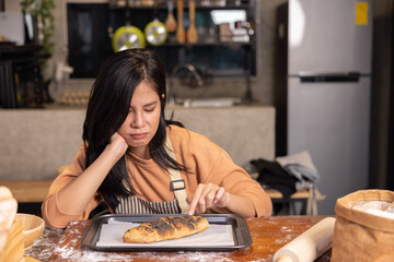 Upset Woman Look at the Her Overcooked Burnt Bread from the Oven