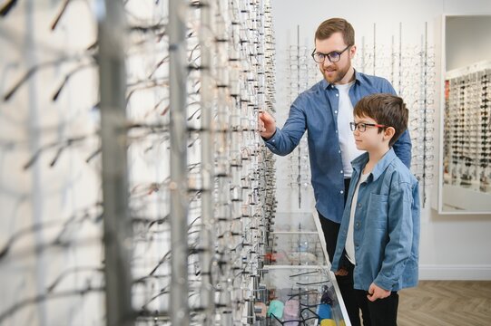 Father With Cute Son. Family Buy Glasses