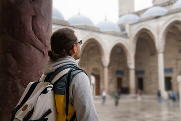 Fototapeta na wymiar person walking in the city. traveler in the mosque. journey to the eastern country.