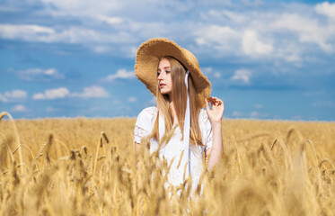 Young beautiful blonde girl in a straw hat