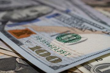 One hundred US dollar banknotes, portrait of Benjamin Franklin, macro shot with bokeh effect