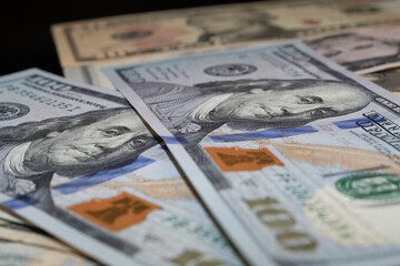 One hundred US dollar banknotes, portrait of Benjamin Franklin, macro shot with bokeh effect