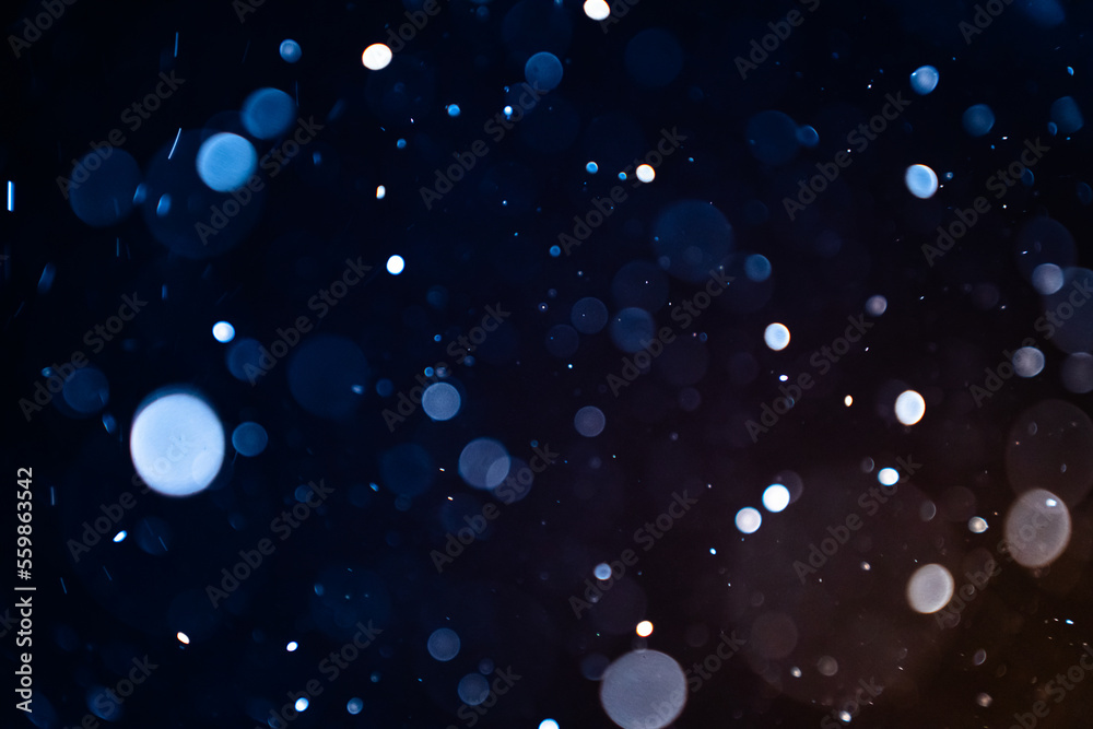 Wall mural closeup of dust particles on black background bokeh blur overlay effect with copy space for text. hi