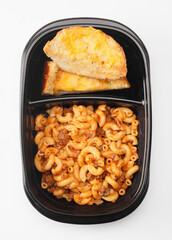 Macaroni and hamburger with melted cheese on garlic bread