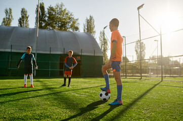 Young boys in sports soccer club on training unit improving skills