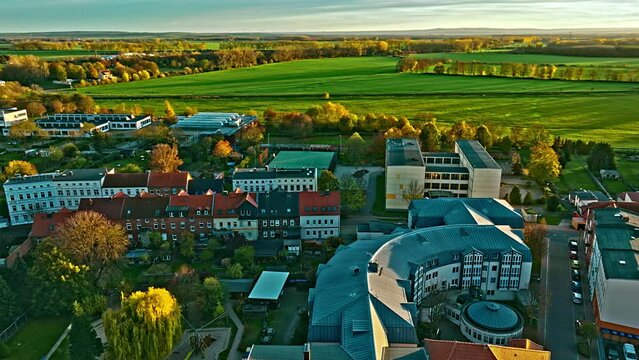 Aerial view of Golden Sunset of green Fields in Oschersleben . Drone flight over village with green field in background . Oschersleben is a town in the Börde district, in Saxony-Anhalt, Germany