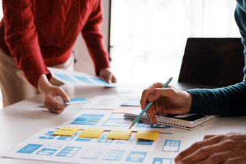 Designer, programmers, developers of mobile applications work together to invent a modern mobile application system.