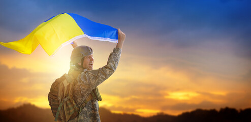 War in Ukraine. Soldier with Ukrainian flag.