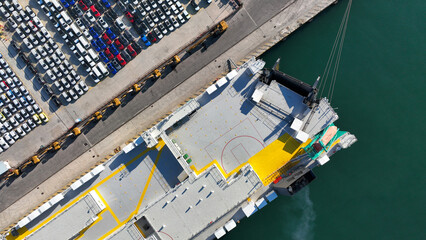 Aerial drone top down photo of new cars lined up in automobile Ro Ro port terminal for import and export