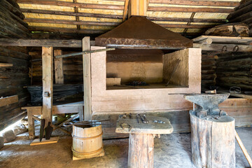 Fototapeta na wymiar Interior of an old country forge with anvil and the tools